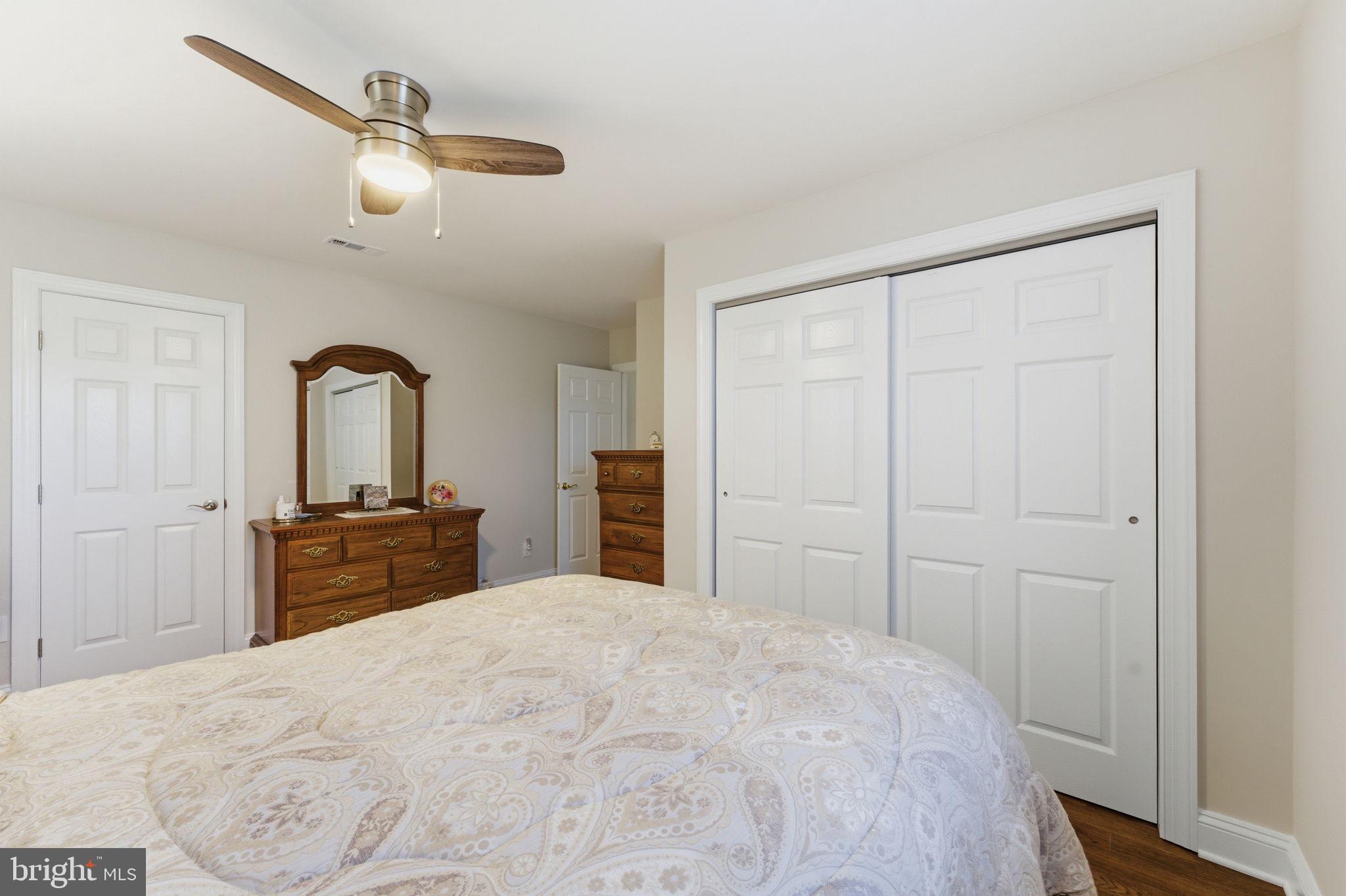 6163 Georgetown Road Broad Run, VA 20137 - Photo 47 of 94 a bedroom with a bed and a chandelier