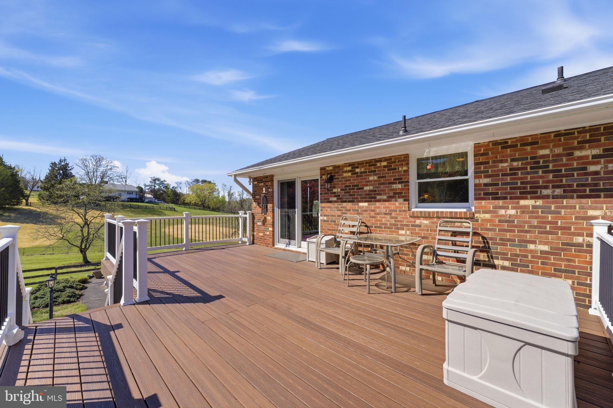 6163 Georgetown Road Broad Run, VA 20137 - Photo 55 of 94 a view of a roof deck with table and chairs a barbeque with wooden floor and fence