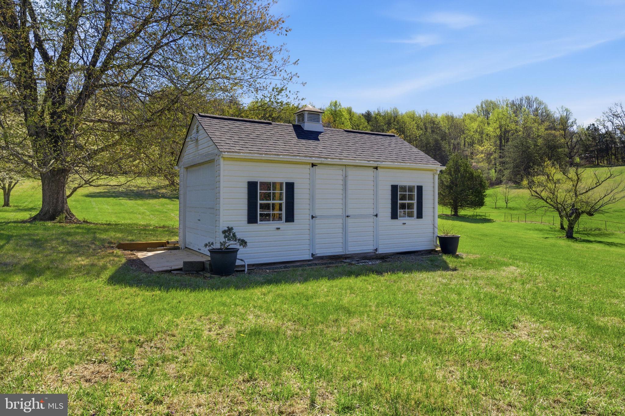 6163 Georgetown Road Broad Run, VA 20137 - Photo 59 of 94 a front view of a house with a yard and garage