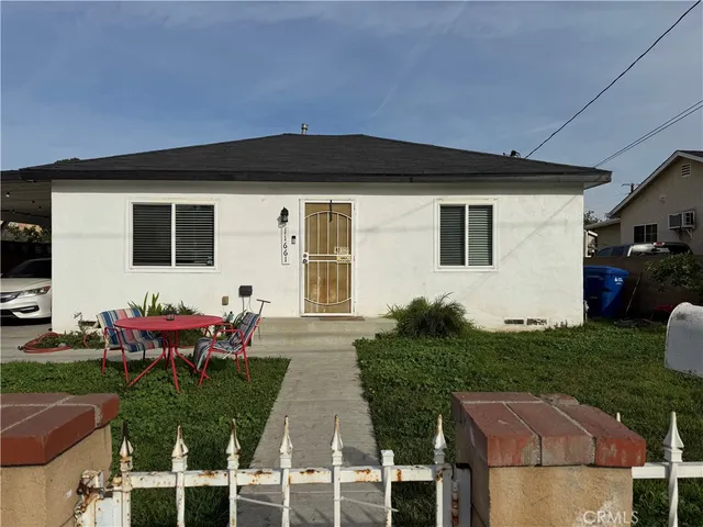 a view of a house with backyard sitting area and furniture