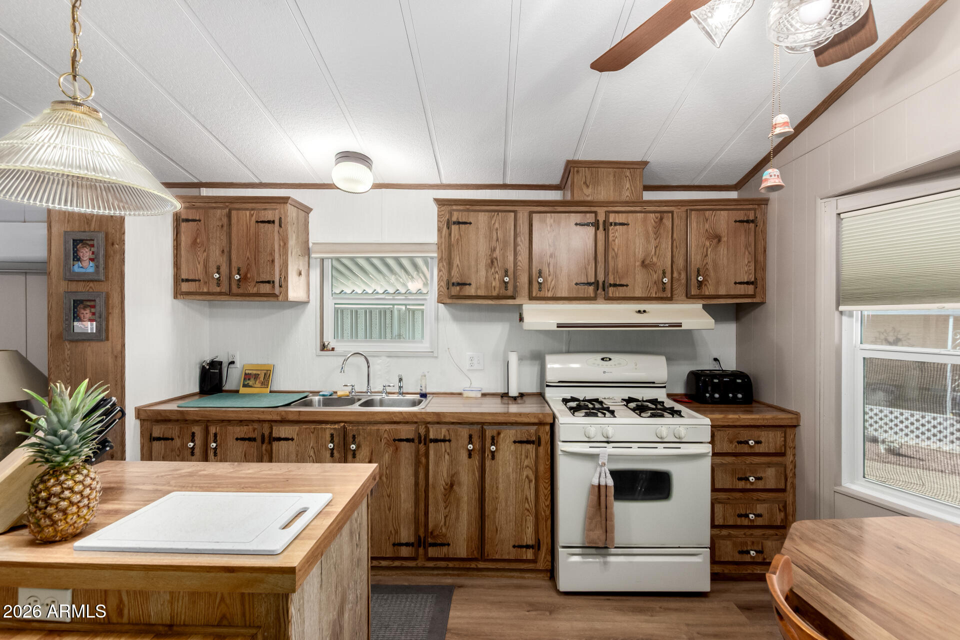 269 North Winchester Road, Unit 66 Apache Junction, AZ 85119 - Photo 12 of 28 a kitchen with a stove a sink and cabinets