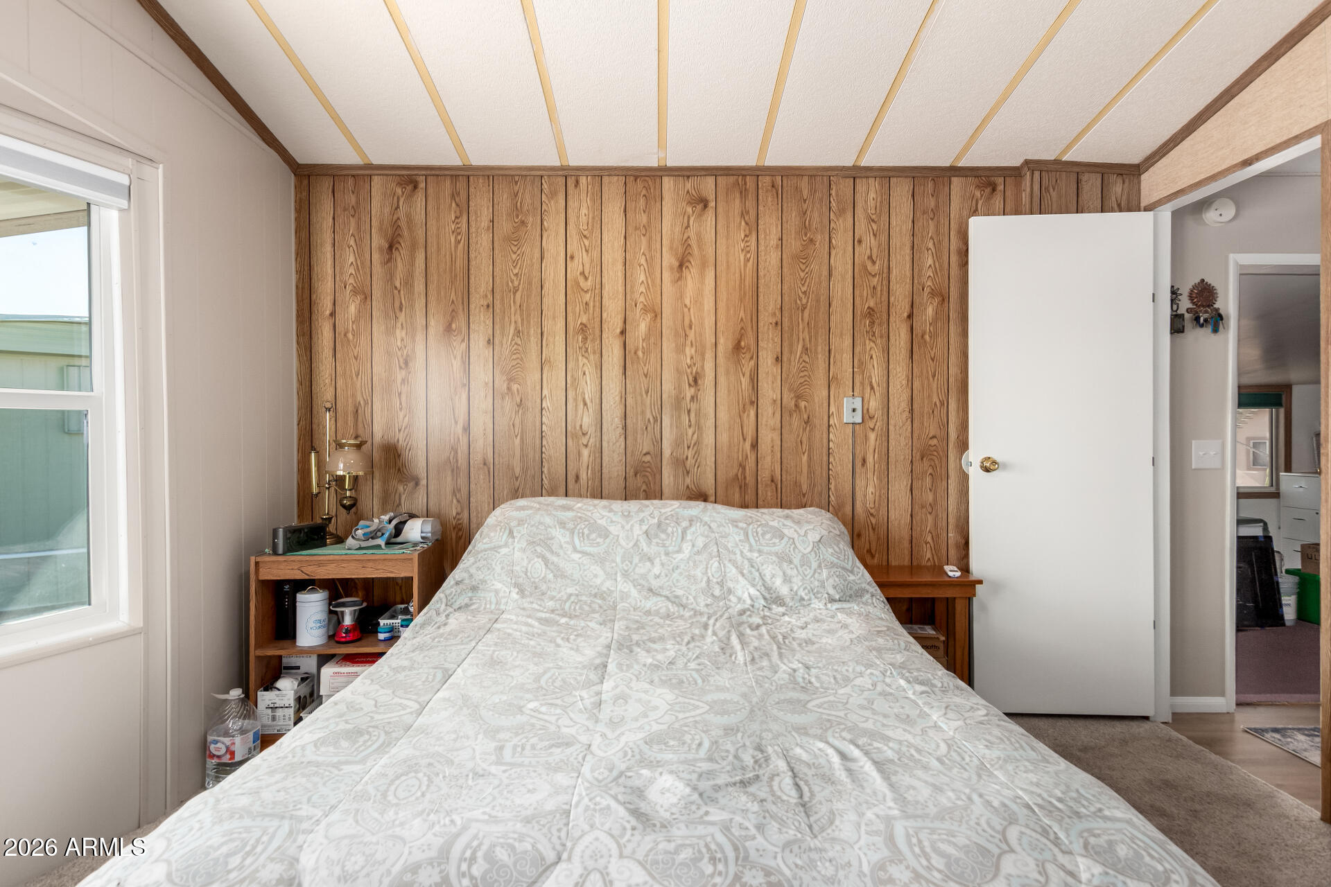 269 North Winchester Road, Unit 66 Apache Junction, AZ 85119 - Photo 13 of 28 a view of a bedroom with wooden floor and a window