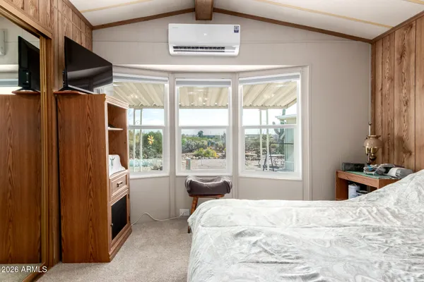 a bedroom with a bed dresser and a window