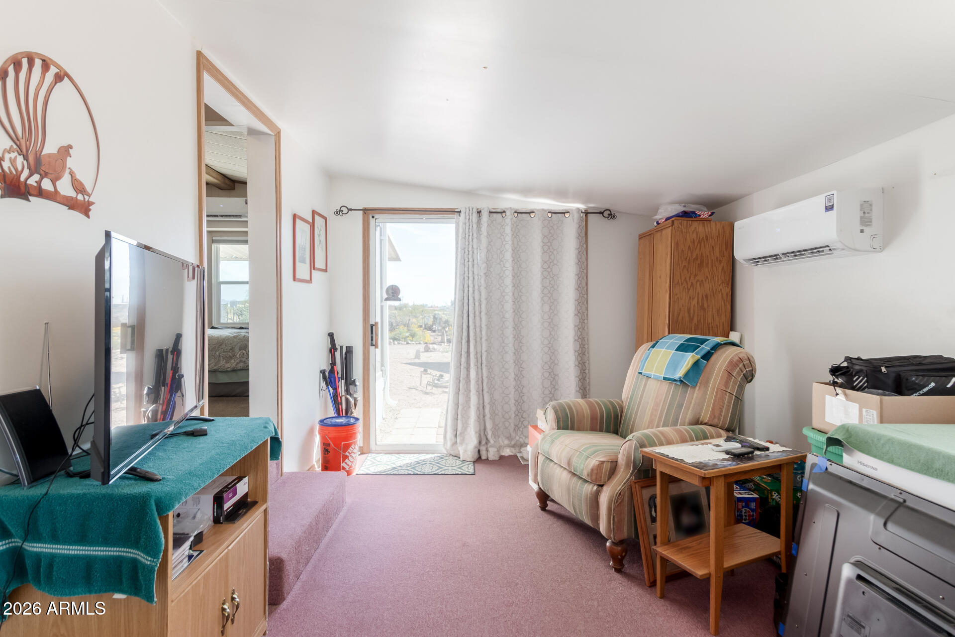 269 North Winchester Road, Unit 66 Apache Junction, AZ 85119 - Photo 24 of 28 a living room with furniture a flat screen tv and a refrigerator