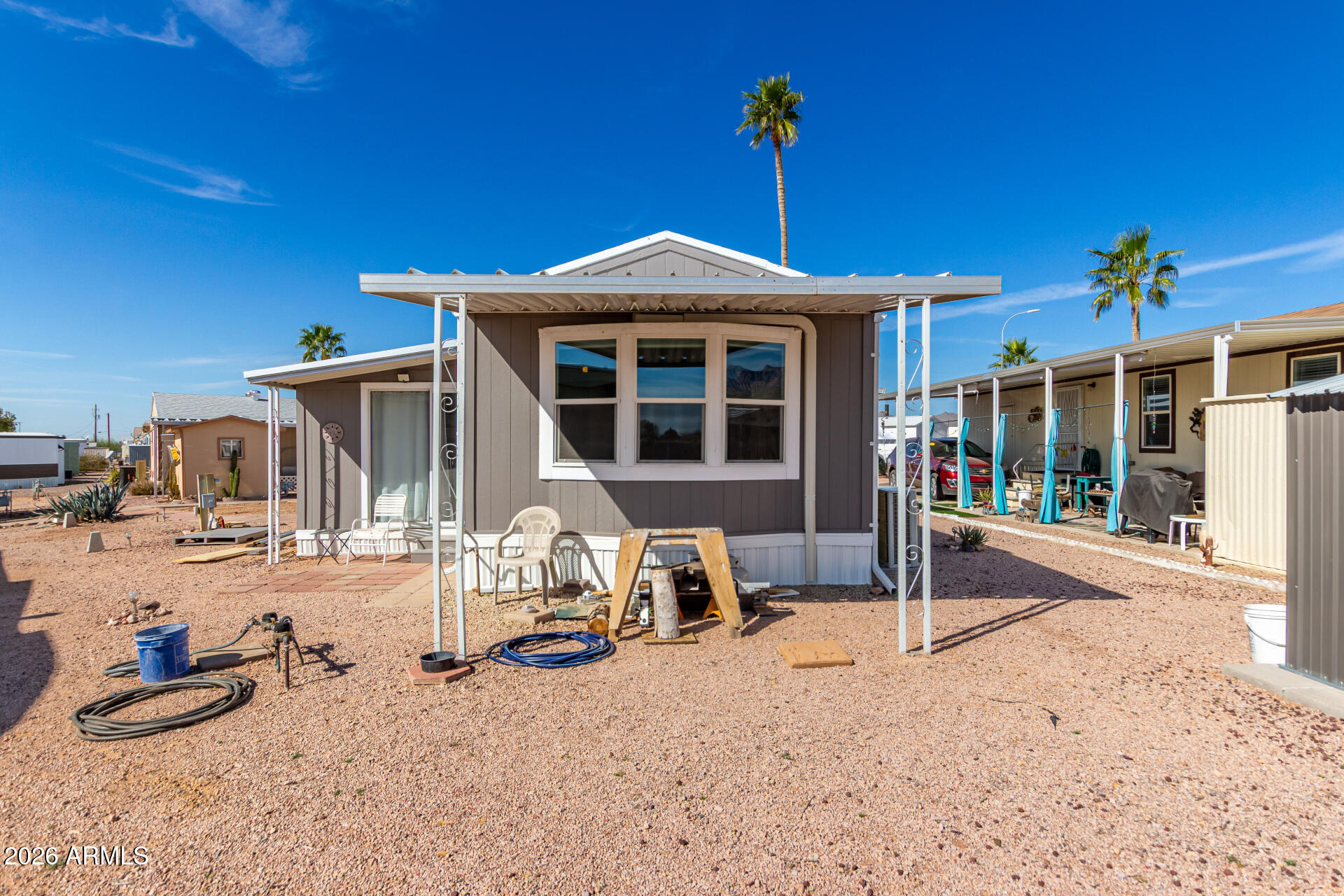 269 North Winchester Road, Unit 66 Apache Junction, AZ 85119 - Photo 27 of 28 a front view of a house with a yard outdoor seating space