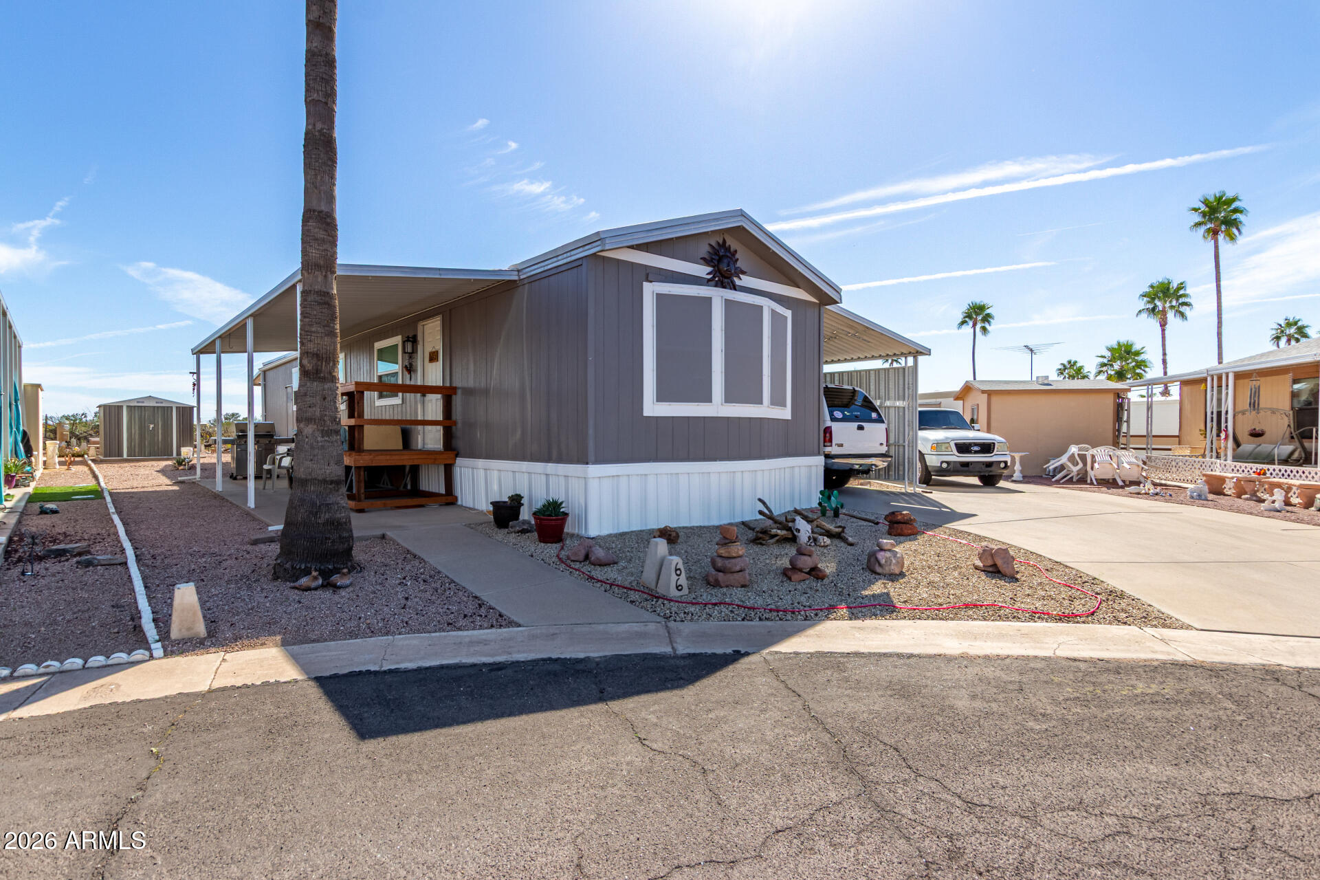 269 North Winchester Road, Unit 66 Apache Junction, AZ 85119 - Photo 3 of 28 a living room with furniture a fireplace and potted plants