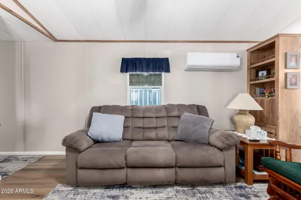 a living room with furniture a couch and a bookshelf