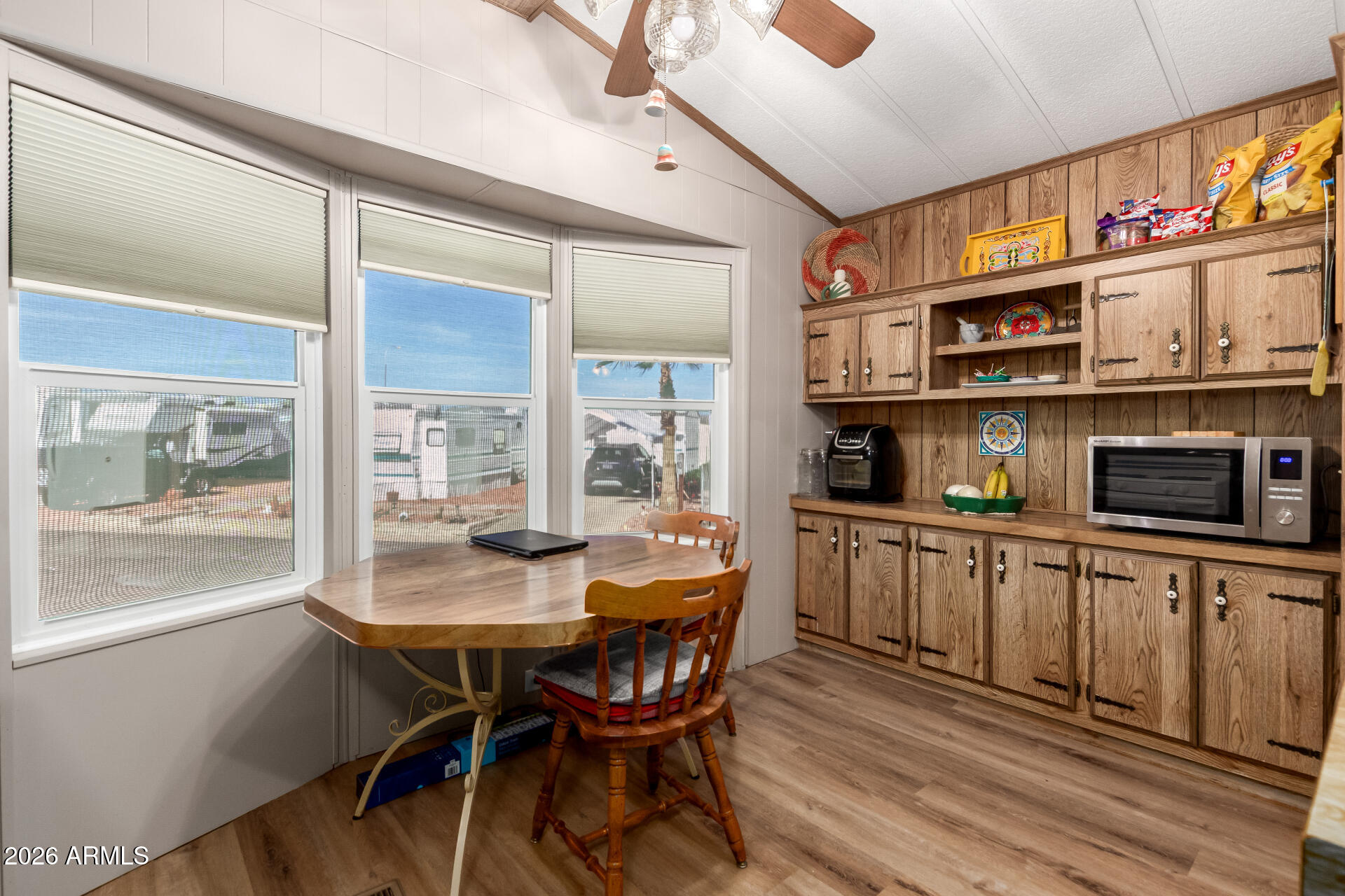 269 North Winchester Road, Unit 66 Apache Junction, AZ 85119 - Photo 9 of 28 a view of a dining room with furniture window and wooden floor