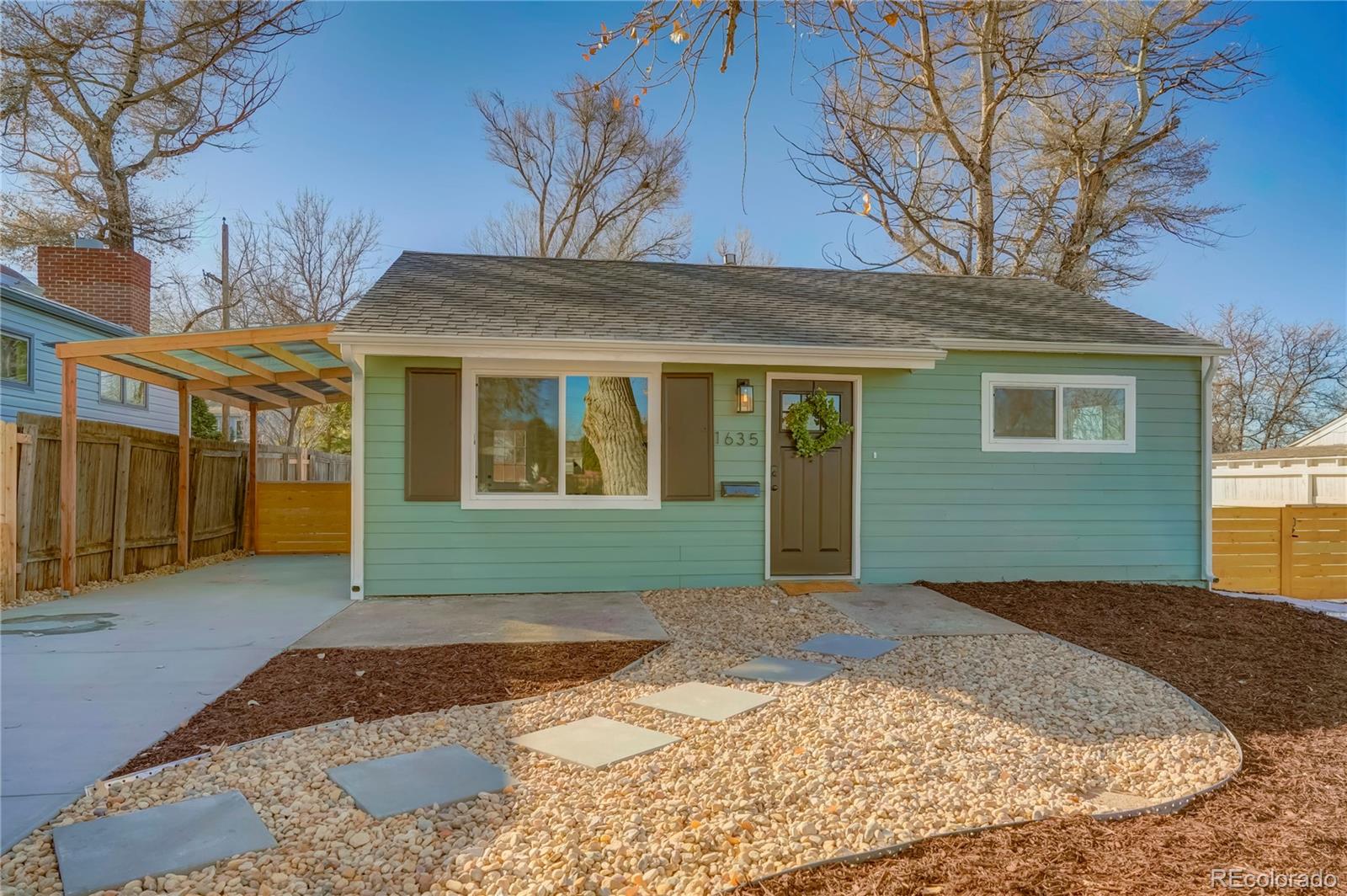 1635 South Raritan Street Denver, CO 80223 - Photo 13 of 17 a view of a house with a yard