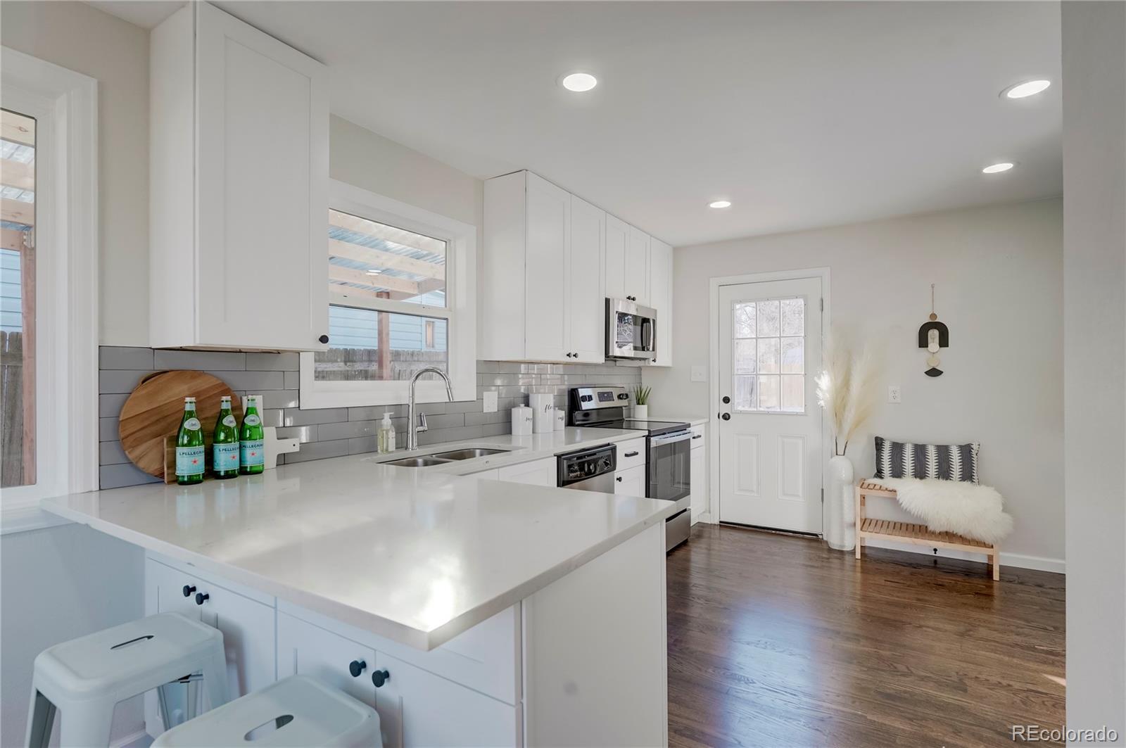 1635 South Raritan Street Denver, CO 80223 - Photo 2 of 17 a kitchen with sink cabinets and living room