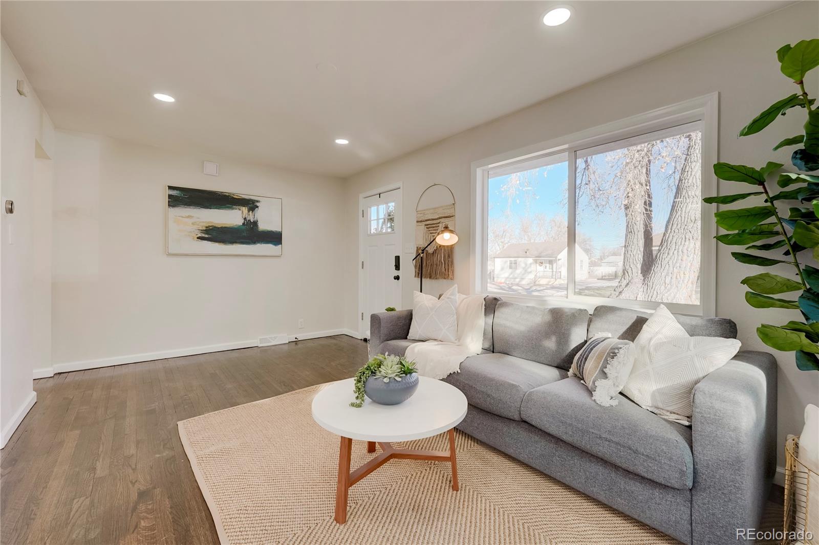 1635 South Raritan Street Denver, CO 80223 - Photo 6 of 17 a living room with furniture and a large window
