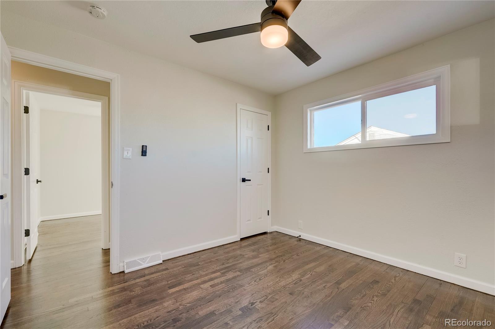 1635 South Raritan Street Denver, CO 80223 - Photo 8 of 17 a view of empty room with wooden floor
