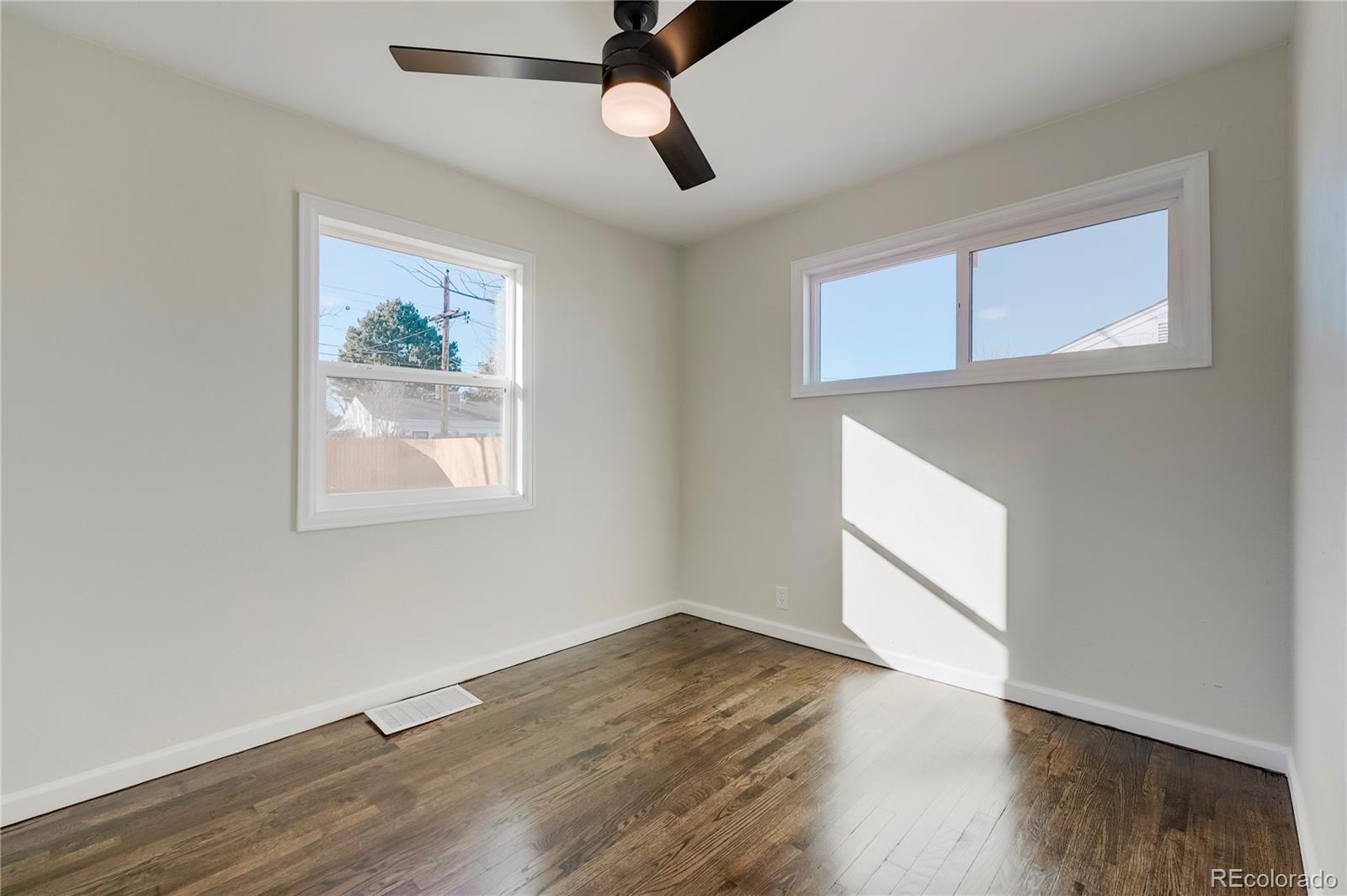 1635 South Raritan Street Denver, CO 80223 - Photo 10 of 17 wooden floor in an empty room with a window