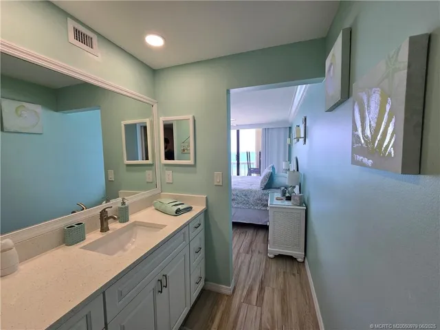 a en suite bathroom with a sink and mirror