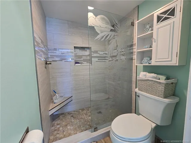 a white toilet sitting next to a bathroom sink