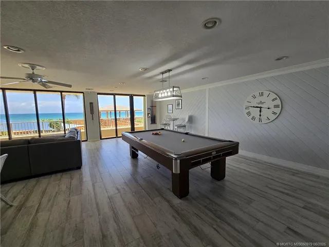 an empty room with wooden floor and large window
