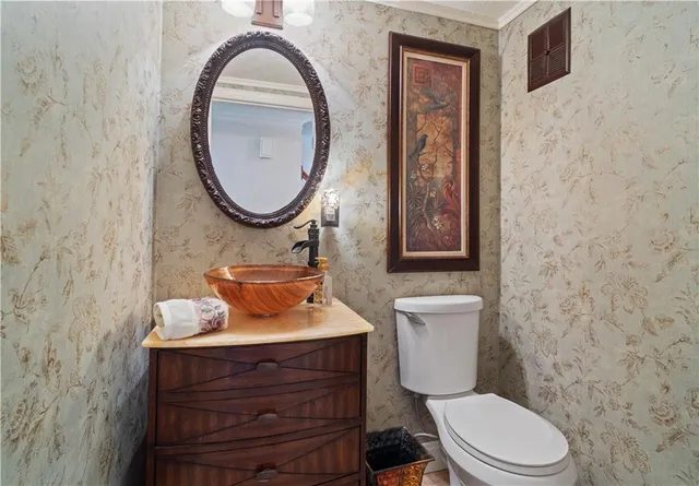 a bathroom with a toilet a sink and mirror
