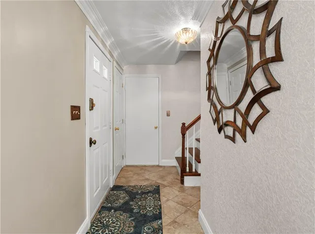 a view of an entryway with wooden floor and mirror