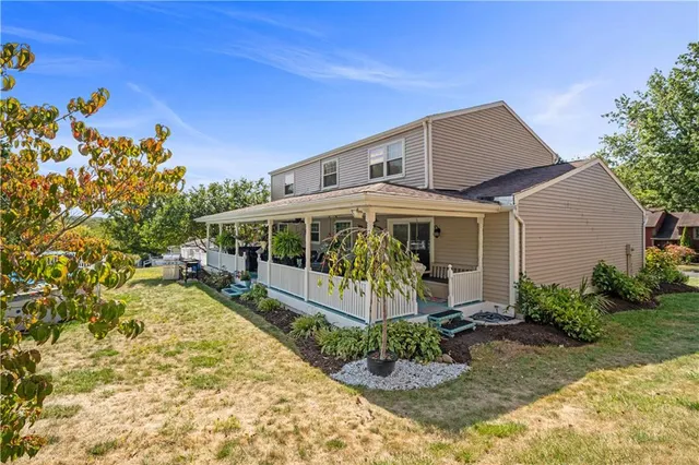 a view of a house with a small yard and plants