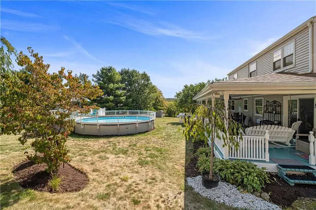 a view of a house with a yard and sitting area