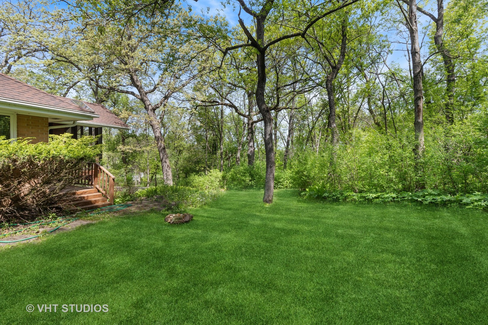 26848 Highway 22 Barrington, IL 60010 - Photo 31 of 38 a backyard of a house with plants and large trees