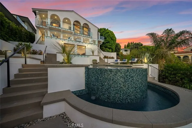 a view of a grey house with a yard