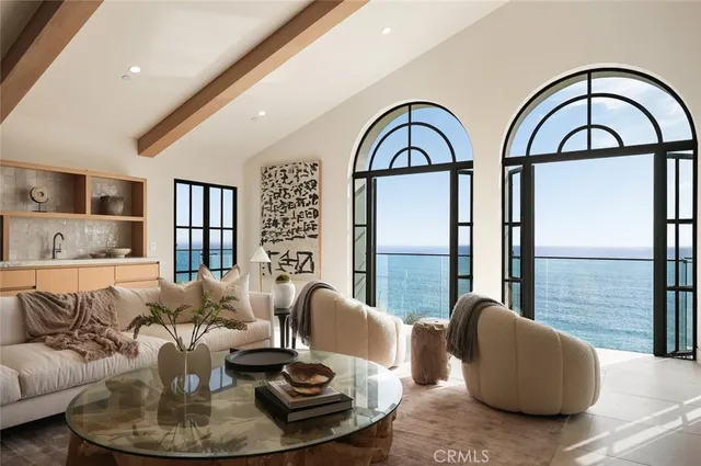 a living room with furniture large window and wooden floor