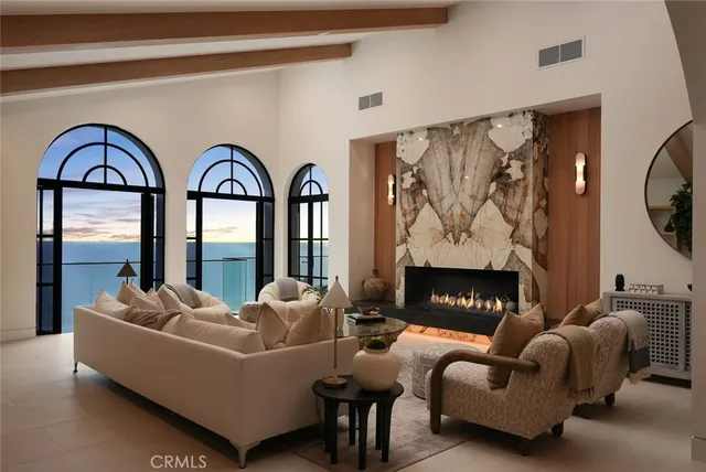 a living room with couches and a floor to ceiling window