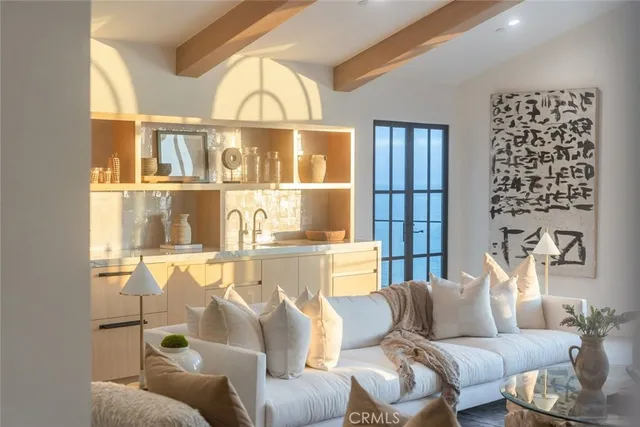 a living room with furniture potted plant and chandelier