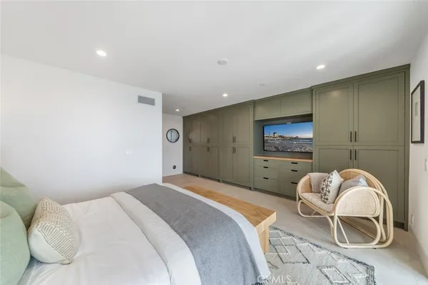 a spacious bedroom with a bed and a large window