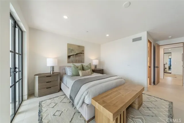 a bedroom with a large bed and a window