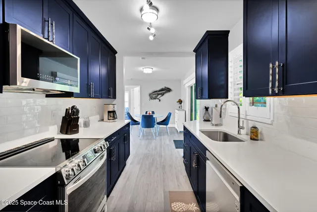 a kitchen with a sink stove top oven and cabinets