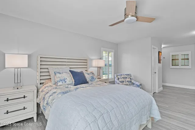 a bedroom with a large bed and a lamp on dresser