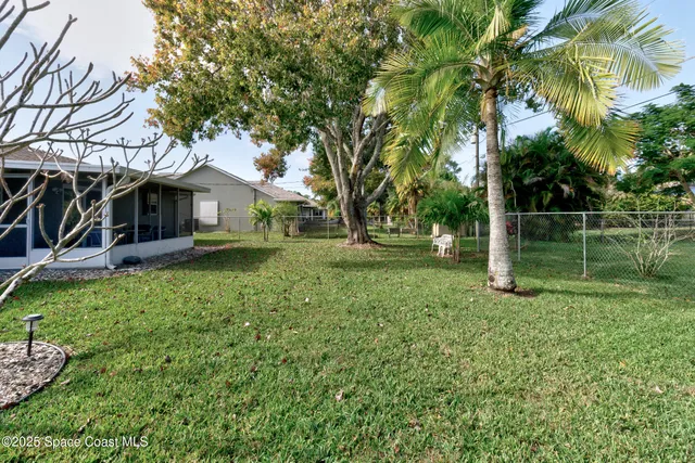 a view of a house with yard and a tree