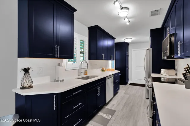 a spacious bathroom with a double vanity sink and a large mirror