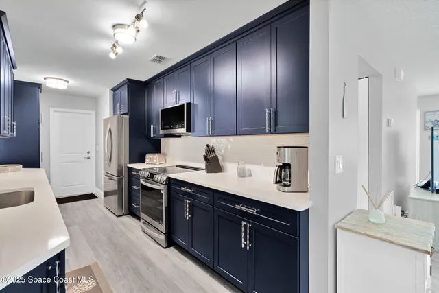 a kitchen with a sink appliances and cabinets