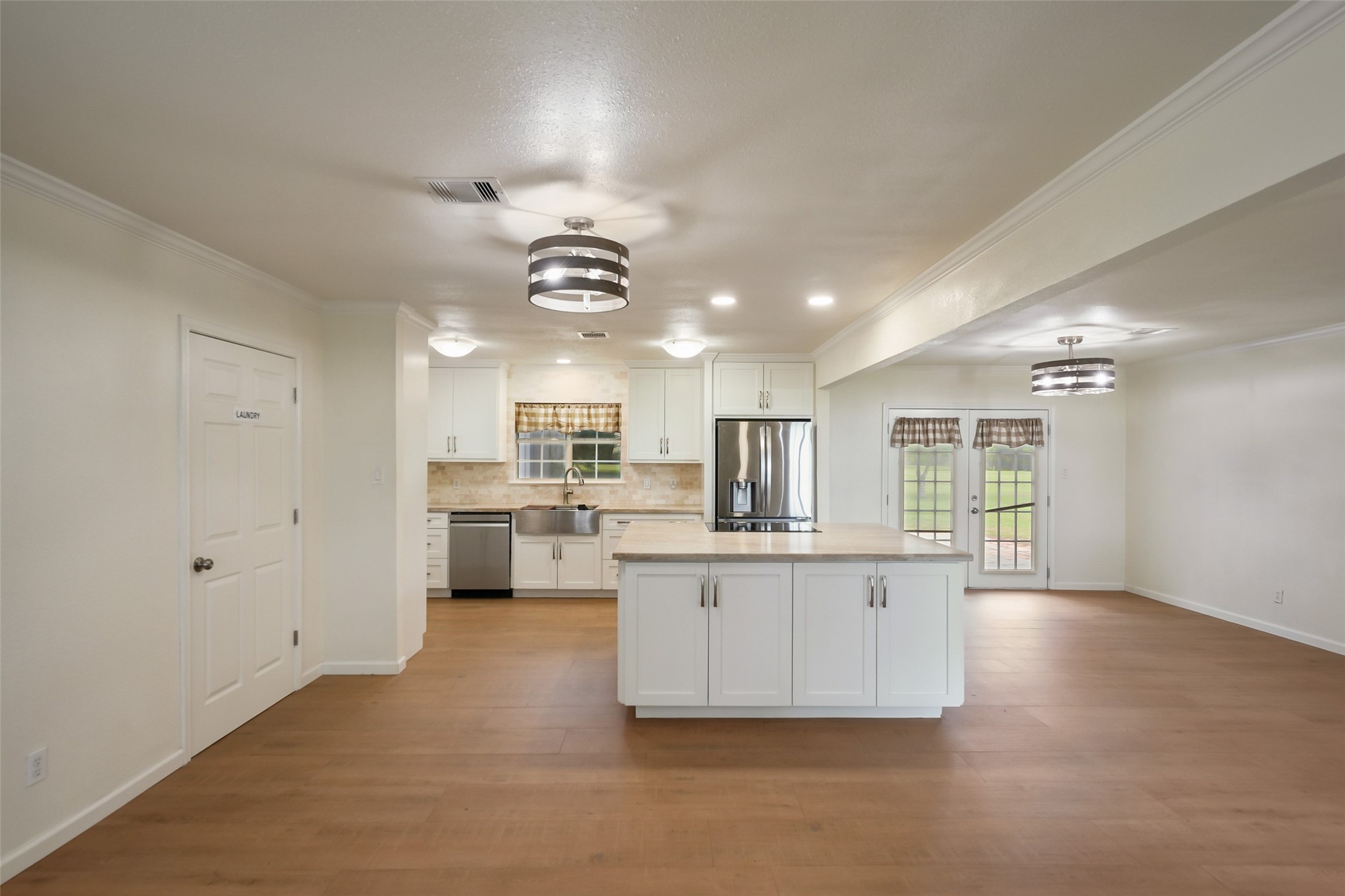19635 Kermier Road Waller, TX 77484 - Photo 7 of 27 Open-concept living area flows seamlessly into the kitchen, creating an ideal space for everyday living and entertaining.