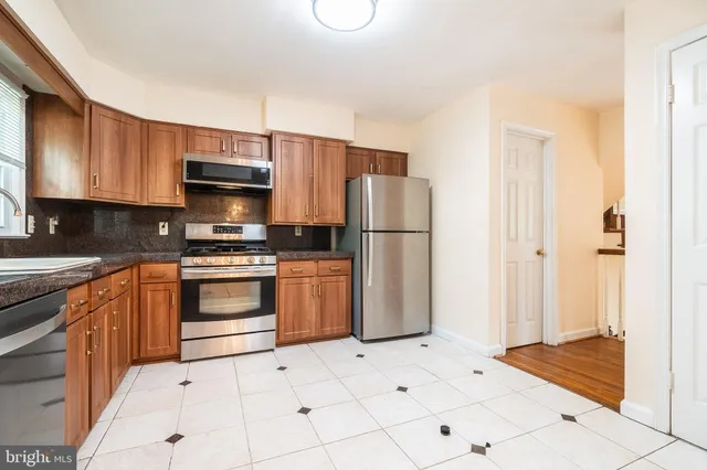 a kitchen with stainless steel appliances a refrigerator sink and cabinets