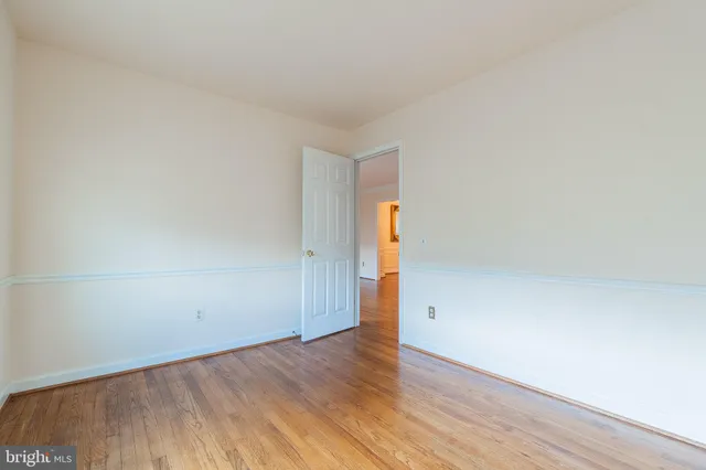 an empty room with wooden floor