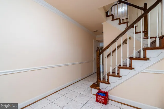 a view of entryway with wooden floor and stairs
