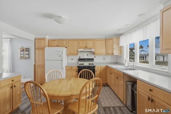 a kitchen with a refrigerator and a stove top oven