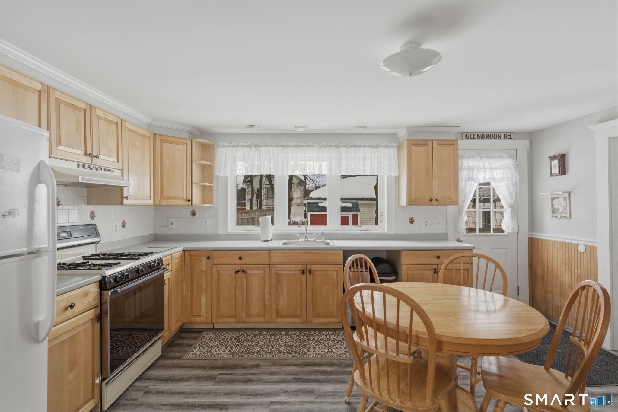 23 Benham Street Torrington, CT 06790 - Photo 12 of 28 a kitchen with stainless steel appliances granite countertop a stove top oven a sink dishwasher and white cabinets with wooden floor