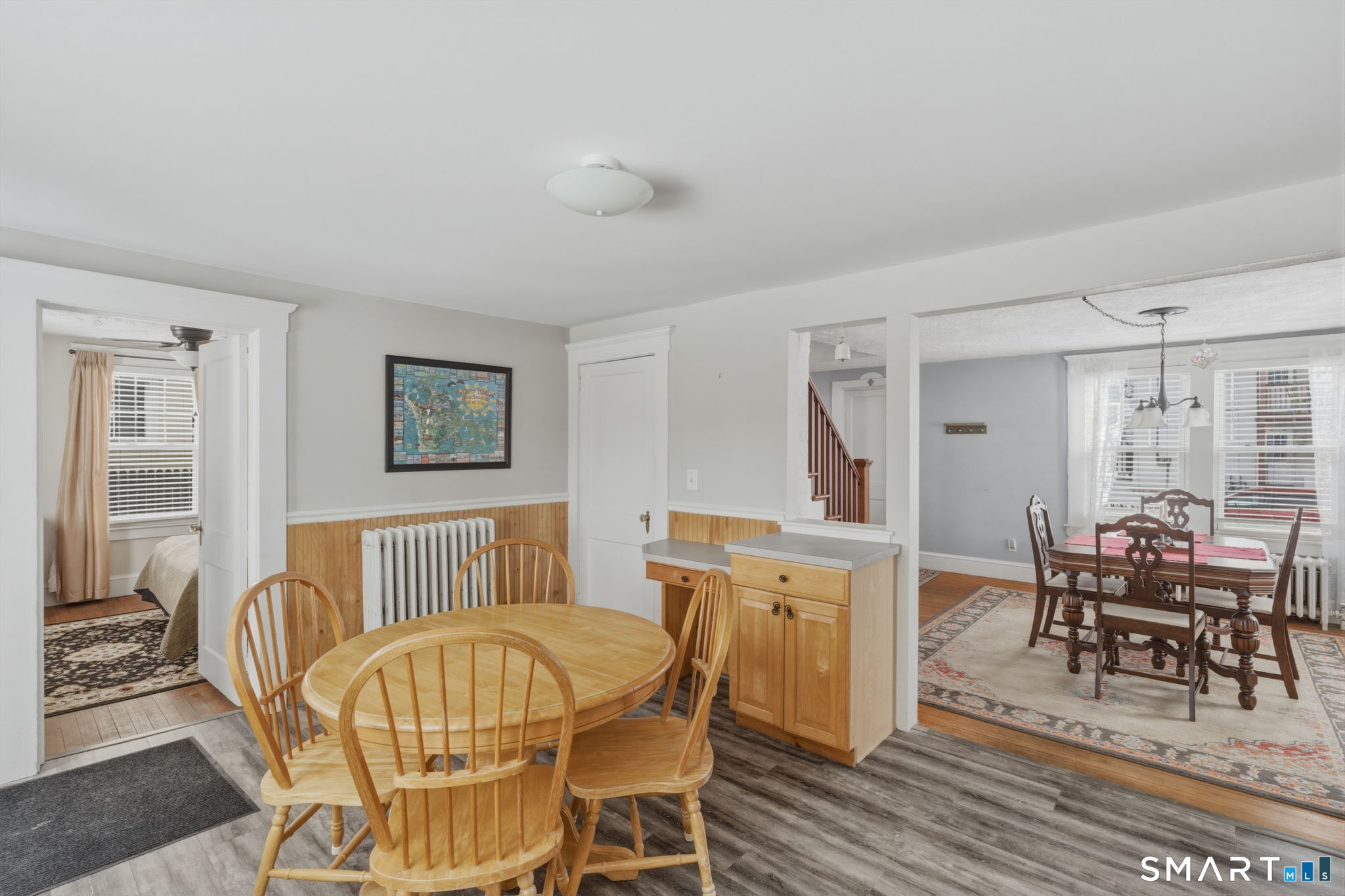 23 Benham Street Torrington, CT 06790 - Photo 15 of 28 a living room with furniture and a dining table with wooden floor