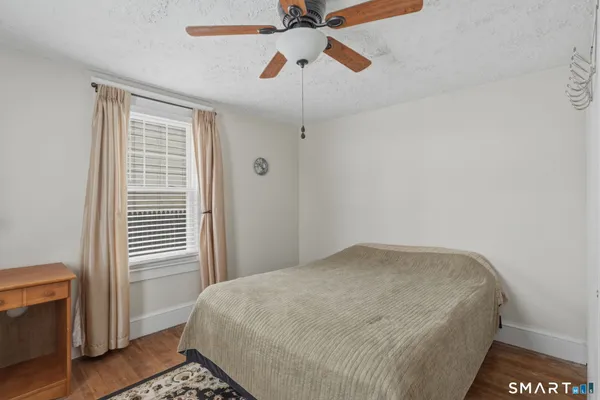 a bed sitting in a bedroom next to a window