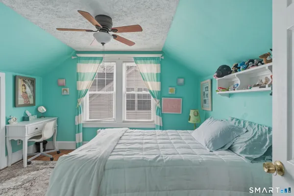 a bedroom with a large bed and a window