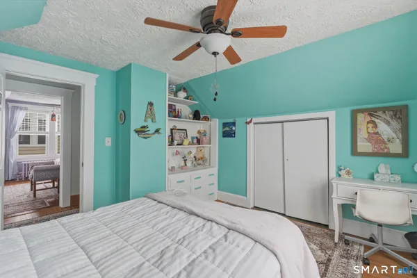 a bedroom with a bed and a workspace