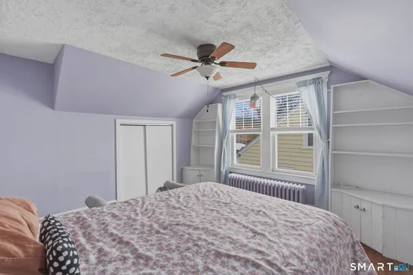 a bedroom with a bed dresser and a window