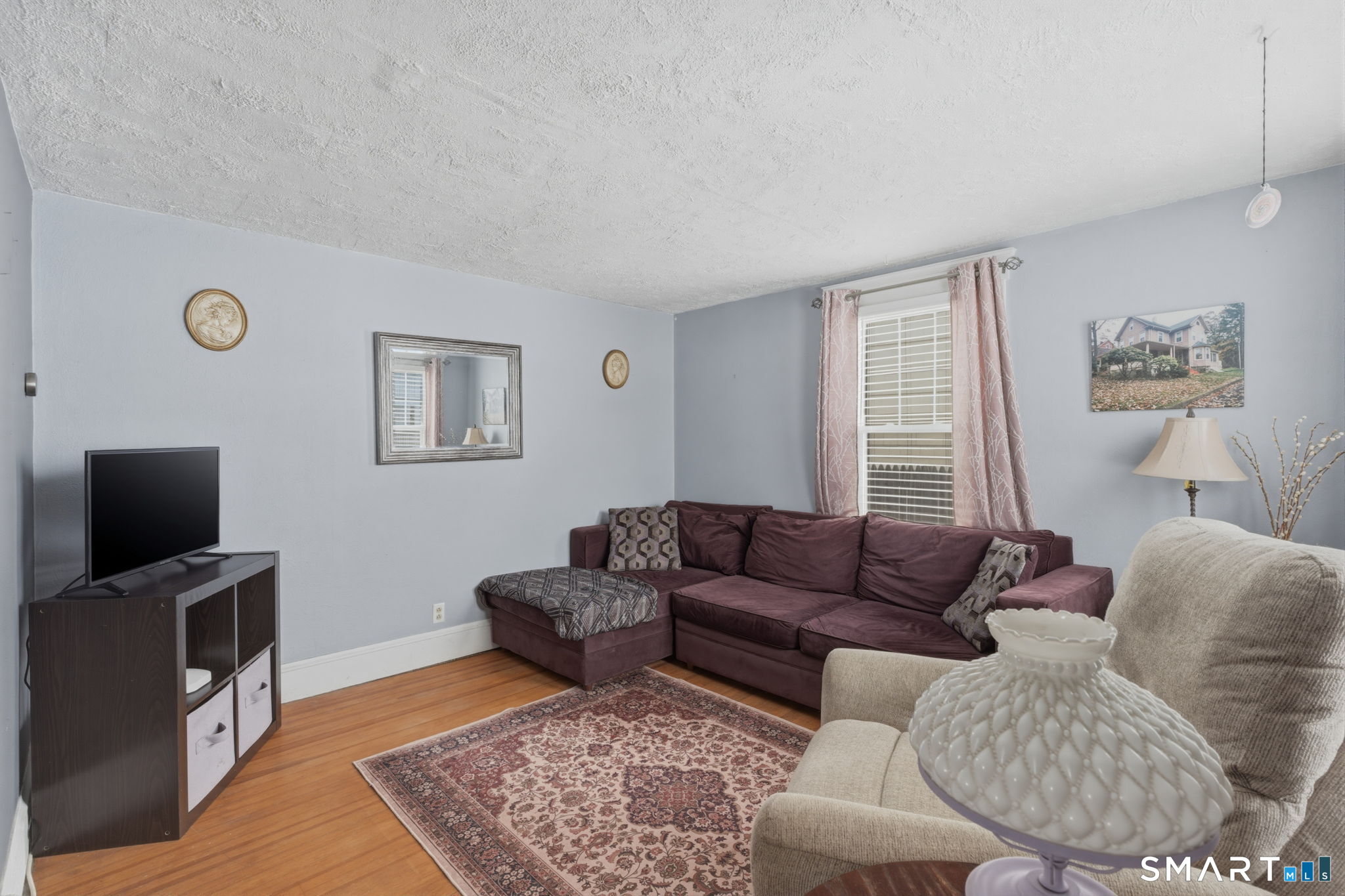23 Benham Street Torrington, CT 06790 - Photo 26 of 28 a living room with furniture and a flat screen tv