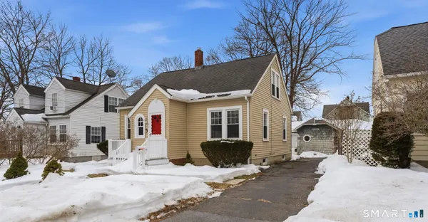 a view of a house with snow on the road