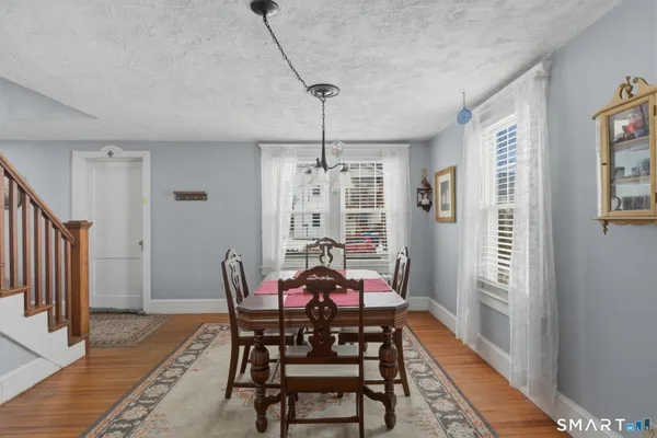 a view of a dining room with furniture window and wooden floor